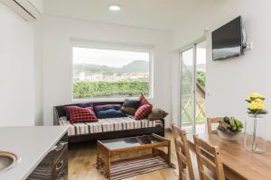 a living room with a couch and a window at Casa Azul da Beija in Furnas