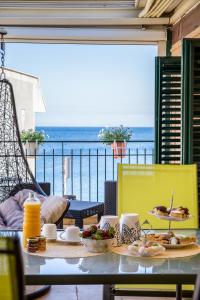 a table with food on it with a view of the ocean at Casa Piano di Gallo in Mondello