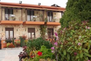 a building with flowers in front of it at Lozitsi in Veria