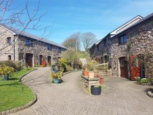 a stone building with a walkway in front of it at King's Head Inn in Llangennith