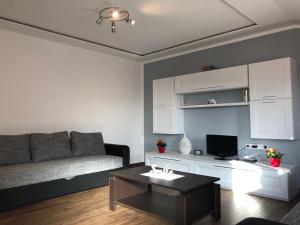 a living room with a couch and a coffee table at Apartment Jopa in Šibenik
