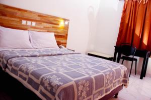 Postel nebo postele na pokoji v ubytování Golden Hôtel