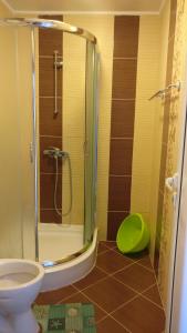 a bathroom with a glass shower with a toilet at Club Priz in Primorsko