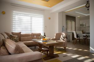 a living room with a couch and a table at Apartments Sunny Hill in Tivat