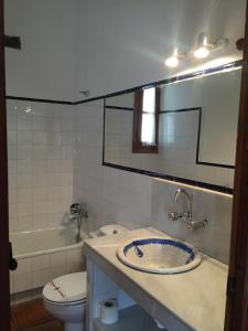 a bathroom with a sink and a toilet and a mirror at Camping El Balcon de Pitres in Pitres