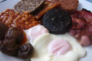 a plate of breakfast food with eggs beans and meat at King's Head Inn in Llangennith