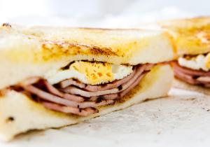 a sandwich with ham and eggs on a wrapper at King's Head Inn in Llangennith