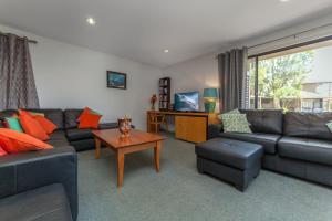 a living room with a couch and a table at Condo 105 @ Horizons Golf Resort - Salamander Bay NSW in Salamander Bay