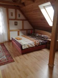 a bedroom with a large bed in a attic at Apartmány pod Hradem in Holštejn