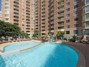 a large swimming pool in front of a large building at National at Ballston Place in Arlington