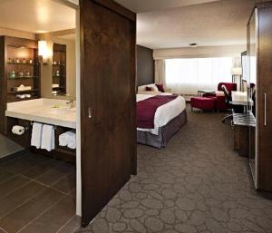 a hotel room with a bed and a bathroom at Crosswaters Resort at Kananaskis in Kananaskis Village