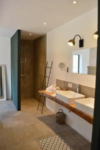 a bathroom with two sinks and a shower at Les Petites Maisons in Sotta +43 photos