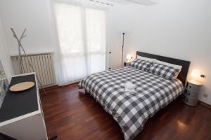 um quarto com uma cama xadrez em preto e branco em Casa Gaia em Stresa