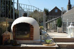a pizza oven sitting on top of a patio at Ashford house 'The Snug' private hot tub in Fylingthorpe