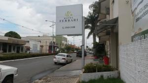 a white car parked on the side of a street at Hotel Ferrari in Lucas do Rio Verde