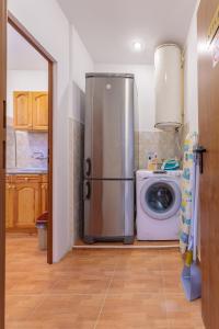 a kitchen with a refrigerator and a washing machine at SeaSide Guest Rooms in Burgas