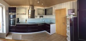 a large kitchen with a blue counter top at Haus Bergzauber in Eschlkam