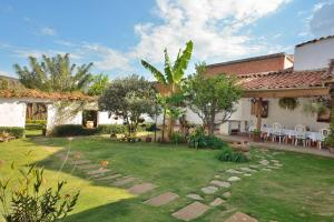 a backyard with a lawn with rocks and trees at Hotel Casa Palosanto in Zapatoca