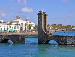 a bridge over a body of water with buildings at Casa el Gallo in Teguise