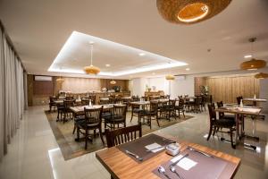 a dining room with tables and chairs and a restaurant at Solaris Hotel in Formosa