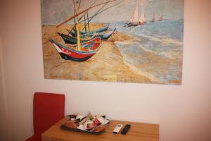 a painting of boats on the beach on a wall at B&B Hospital in Catanzaro