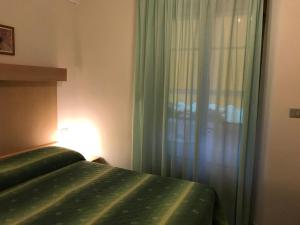 Postel nebo postele na pokoji v ubytování Hotel B&B Rispescia Grosseto