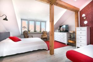 a bedroom with a large bed and a television at Loft Apartments in Gdańsk