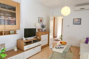 a living room with a tv and a couch at Kaleta in Supetar
