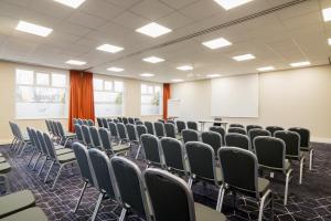 a conference room with chairs and a whiteboard at ibis Rotterdam Vlaardingen in Vlaardingen