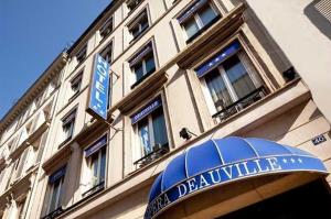 a building with a blue domed sign in front of it at Opera Deauville in Paris