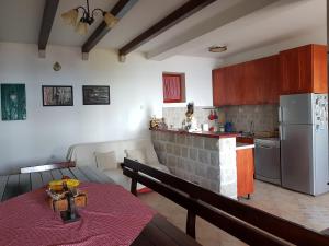 a kitchen with a table and a kitchen with a refrigerator at Casa Di Lukovic II in Tivat