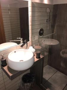 a bathroom with a sink and a shower at Casa Azzurra in Naples