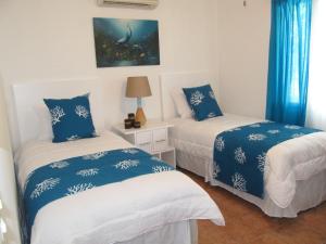 Ένα ή περισσότερα κρεβάτια σε δωμάτιο στο Coco Beach Home