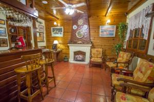 
a living room filled with furniture and a fireplace at Hosteria Sirenuse in Mar del Plata

