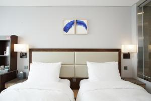 Postel nebo postele na pokoji v ubytování Stanford Hotel Busan