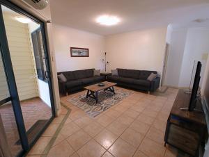 a living room with a couch and a table at Lakeview Apartments in Kununurra