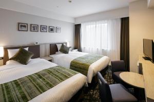
Tempat tidur dalam kamar di Hotel Mystays Kagoshima Tenmonkan
