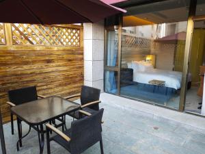 a patio with a bed and a table and chairs at Holiday Inn Express Anshan Downtown, an IHG Hotel in Anshan