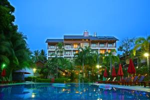 a hotel with a swimming pool in front of a building at Tropicana Resort Phu Quoc in Phú Quốc