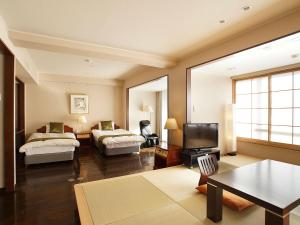 Rúm í herbergi á Atami Onsen Hotel Yume Iroha