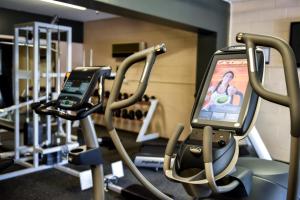 a gym with two cell phones on the treadmill at Waipuna Hotel & Conference Centre in Auckland