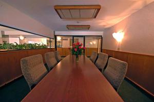 a conference room with a long wooden table and chairs at Yuma Inn & Suites in Yuma +11 photos