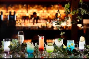 a table topped with glasses of different colored drinks at Kyoto Century Hotel in Kyoto