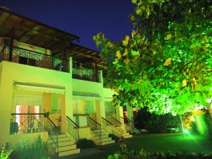 a large house with stairs in a yard at night at Siviri Rental Houses in Siviri