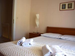 a bedroom with two beds with towels on them at Siviri Rental Houses in Siviri