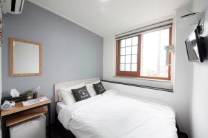Krevet ili kreveti u jedinici u okviru objekta K-Guesthouse Dongdaemun