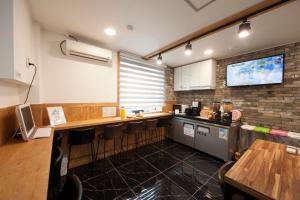 a kitchen with a counter and a tv on the wall at K-Guesthouse Dongdaemun in Seoul