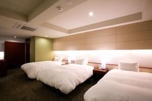 Rúm í herbergi á Kyoto Kamanza Hotel