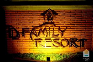 un mur en briques avec un panneau indiquant une intrusion heureuse dans l'établissement D Family Resort, à Anurâdhapura