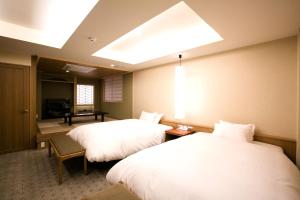 Rúm í herbergi á Kyoto Kamanza Hotel